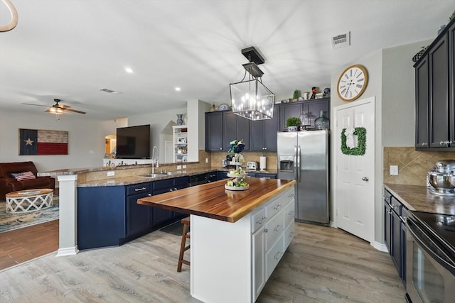 2304 Ranch House Dr, Denton, TX 76210 - kitchen featuring stainless steel fridge with ice dispenser, wooden counters, a sink, open floor plan, and light wood finished floors