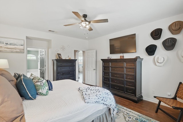2304 Ranch House Dr, Denton, TX 76210 - bedroom with baseboards, dark wood-style floors, a ceiling fan, and connected bathroom