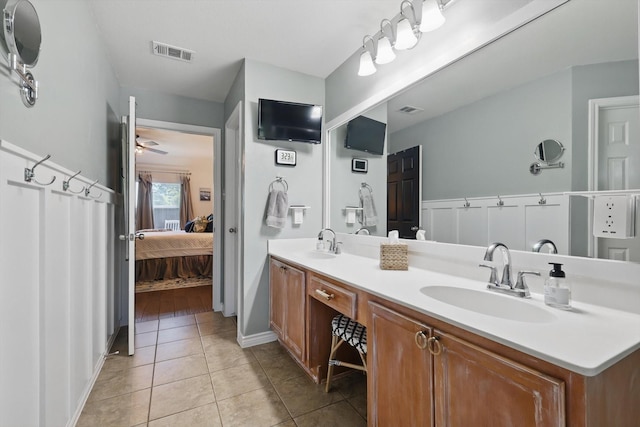 2304 Ranch House Dr, Denton, TX 76210 - full bathroom with connected bathroom, double vanity, tile patterned flooring, ceiling fan, and baseboards