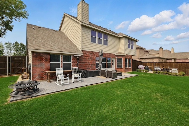 2304 Ranch House Dr, Denton, TX 76210 - rear view of property featuring brick siding, a patio, a chimney, and an outdoor living space with a fire pit
