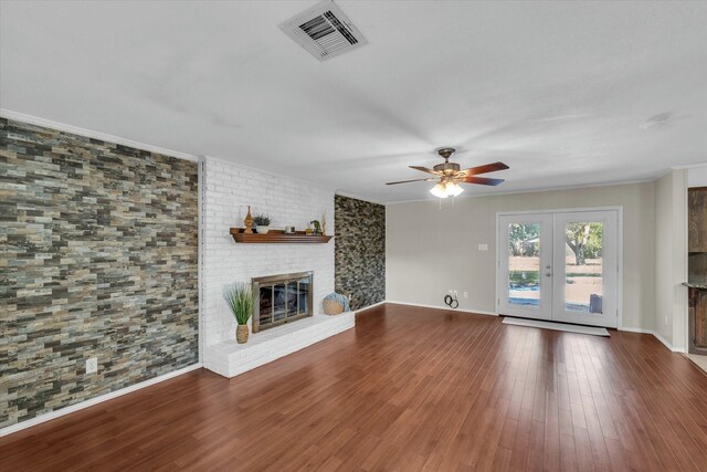 408 Texas Ave, Hewitt, TX 76643 - unfurnished living room featuring a ceiling fan, a brick fireplace, wood finished floors, french doors, and crown molding