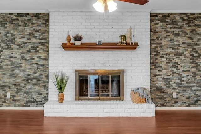 408 Texas Ave, Hewitt, TX 76643 - detailed view of ornamental molding, baseboards, wood finished floors, ceiling fan, and a brick fireplace