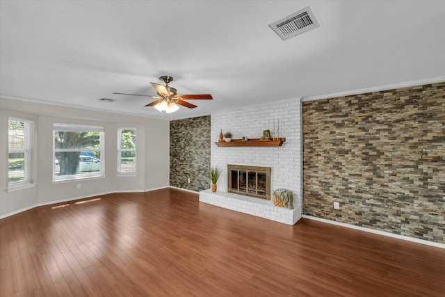 408 Texas Ave, Hewitt, TX 76643 - unfurnished living room featuring a ceiling fan, wood finished floors, a fireplace, baseboards, and crown molding