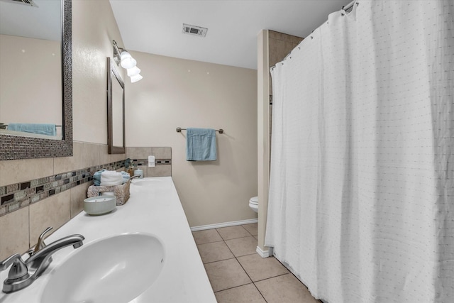 408 Texas Ave, Hewitt, TX 76643 - full bath with tile patterned floors, toilet, double vanity, and baseboards