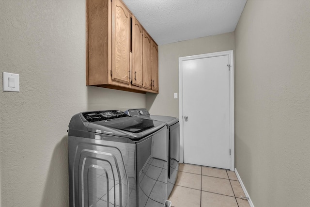 408 Texas Ave, Hewitt, TX 76643 - laundry room with washer and dryer, cabinet space, baseboards, light tile patterned floors, and a textured wall