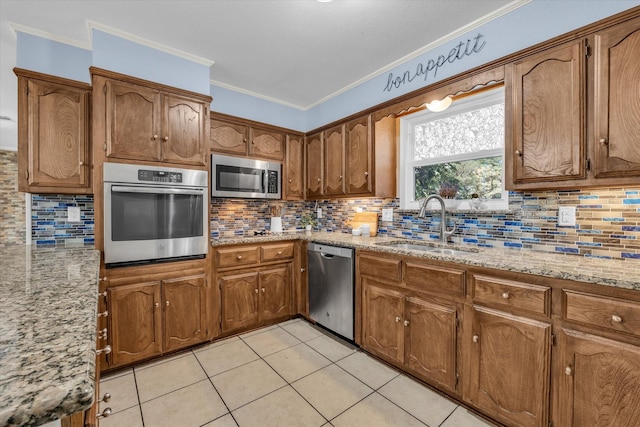 408 Texas Ave, Hewitt, TX 76643 - kitchen with appliances with stainless steel finishes, a sink, tasteful backsplash, ornamental molding, and light tile patterned flooring