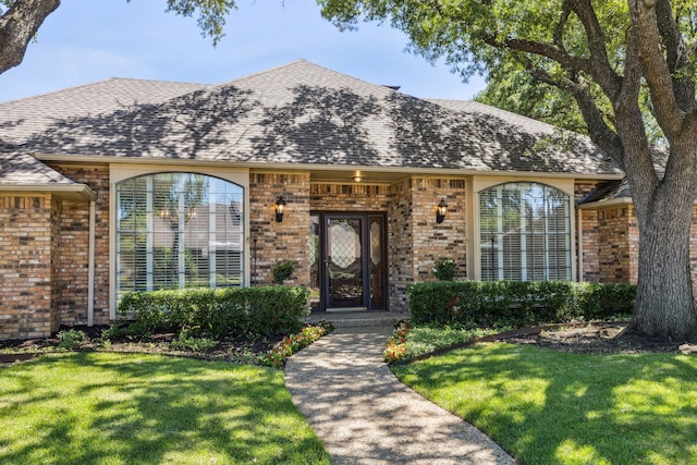 4406 Cobblers Ln, Dallas, TX 75287 - view of front of house featuring brick siding, a front lawn, and a shingled roof