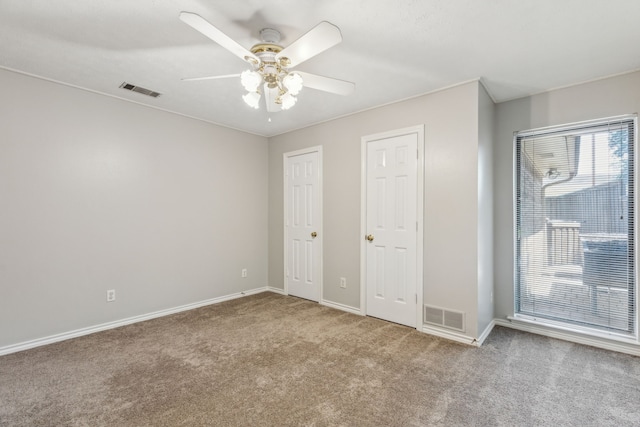 4406 Cobblers Ln, Dallas, TX 75287 - unfurnished bedroom featuring carpet, baseboards, multiple closets, and a ceiling fan