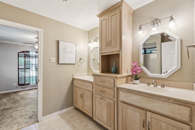 4406 Cobblers Ln, Dallas, TX 75287 - bathroom with double vanity, a ceiling fan, tile patterned floors, and baseboards