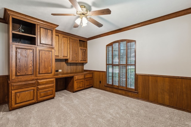 4406 Cobblers Ln, Dallas, TX 75287 - unfurnished office featuring a wainscoted wall, built in study area, wood walls, ceiling fan, and light colored carpet