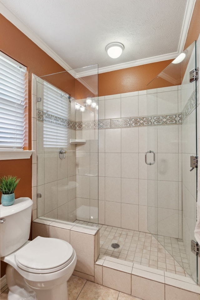 4406 Cobblers Ln, Dallas, TX 75287 - bathroom featuring crown molding, toilet, a stall shower, tile patterned floors, and a textured ceiling