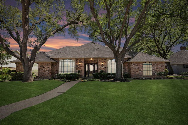 4406 Cobblers Ln, Dallas, TX 75287 - view of front facade featuring a lawn, brick siding, and roof with shingles