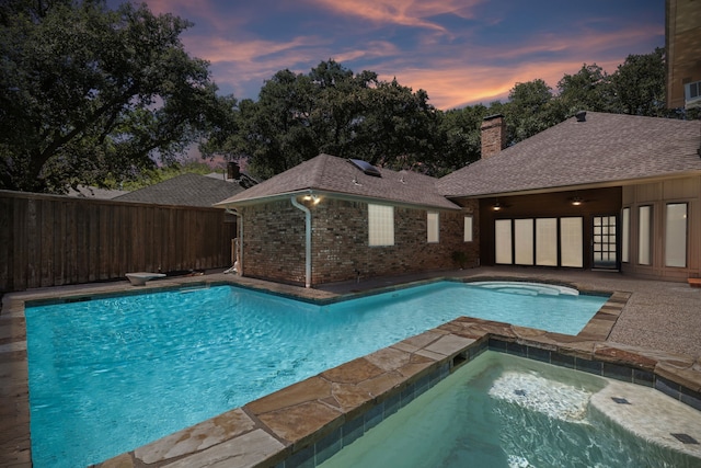 4406 Cobblers Ln, Dallas, TX 75287 - pool at dusk featuring an in-ground hot tub