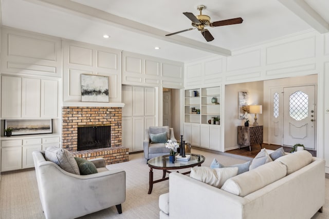 4406 Cobblers Ln, Dallas, TX 75287 - living area featuring a decorative wall, beamed ceiling, ceiling fan, a brick fireplace, and recessed lighting