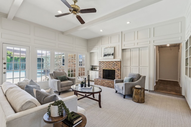 4406 Cobblers Ln, Dallas, TX 75287 - living area featuring a decorative wall, beam ceiling, a ceiling fan, a brick fireplace, and recessed lighting