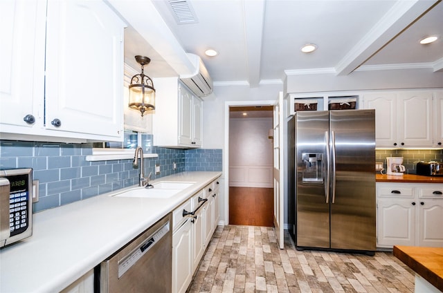 3824 Wagonwheel Ct, Plano, TX 75023 - kitchen featuring appliances with stainless steel finishes, a sink, an AC wall unit, white cabinets, and beamed ceiling