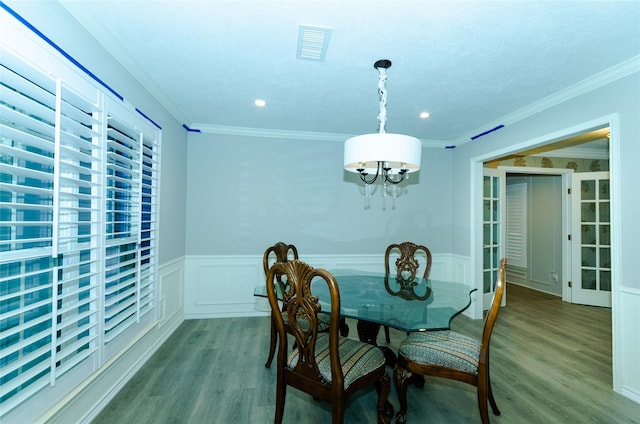 3824 Wagonwheel Ct, Plano, TX 75023 - dining area with wood finished floors, a wainscoted wall, a chandelier, recessed lighting, and crown molding