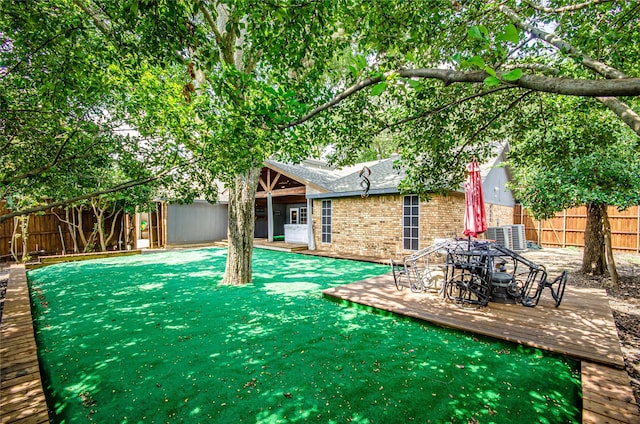 3824 Wagonwheel Ct, Plano, TX 75023 - back of house with a fenced backyard, brick siding, a shingled roof, and a wooden deck