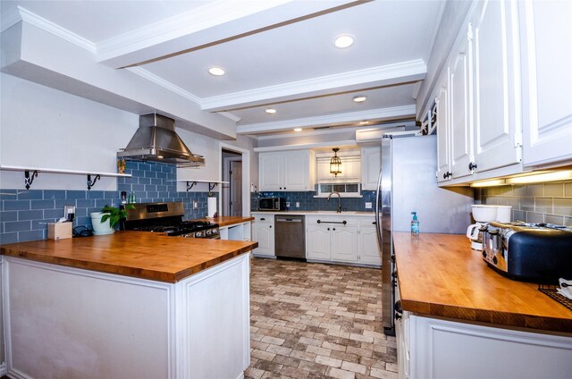 3824 Wagonwheel Ct, Plano, TX 75023 - kitchen with wooden counters, appliances with stainless steel finishes, extractor fan, tasteful backsplash, and white cabinetry