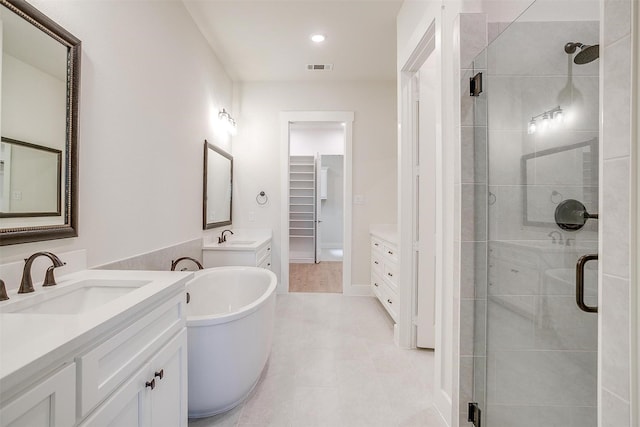 6145 Lucia Dr, Fort Worth, TX 76123 - full bathroom featuring a stall shower, two vanities, a soaking tub, tile patterned flooring, and recessed lighting