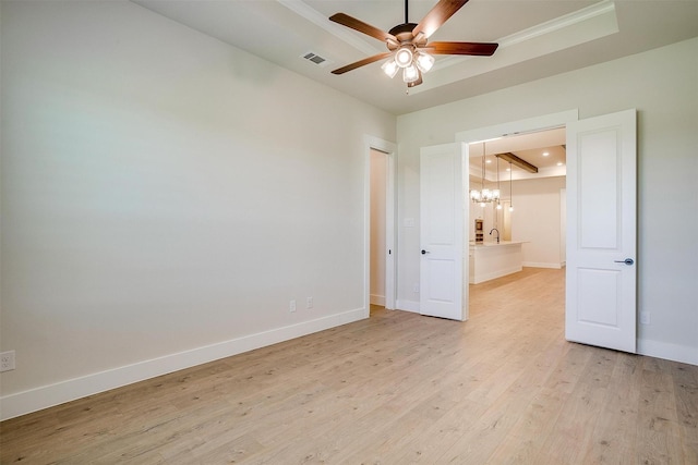 6145 Lucia Dr, Fort Worth, TX 76123 - spare room with a raised ceiling, a chandelier, light wood finished floors, a ceiling fan, and baseboards