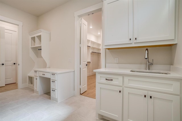 6145 Lucia Dr, Fort Worth, TX 76123 - laundry area featuring a sink, light tile patterned flooring, and baseboards
