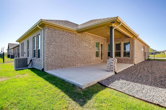 6145 Lucia Dr, Fort Worth, TX 76123 - rear view of property featuring central AC, brick siding, and a patio area