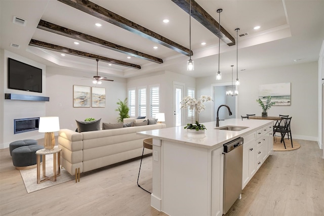 6145 Lucia Dr, Fort Worth, TX 76123 - kitchen with a sink, stainless steel dishwasher, light wood finished floors, white cabinetry, and beam ceiling