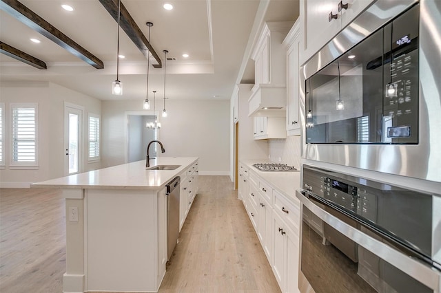 6145 Lucia Dr, Fort Worth, TX 76123 - kitchen featuring appliances with stainless steel finishes, a sink, white cabinets, light wood-style floors, and baseboards