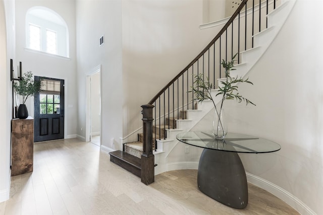 2880 Meadow Dell Dr, Prosper, TX 75078 - entryway featuring a towering ceiling, wood finished floors, baseboards, and stairs