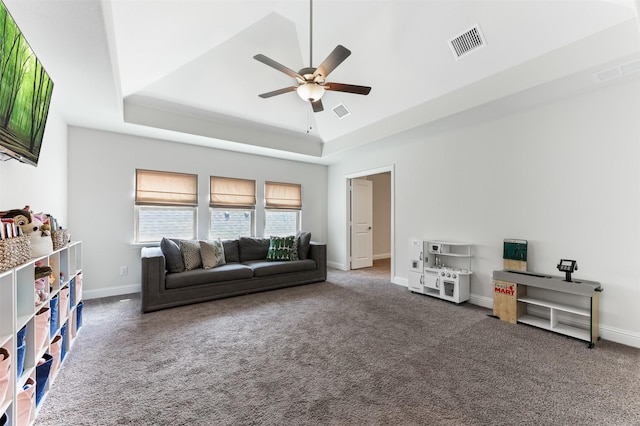 2880 Meadow Dell Dr, Prosper, TX 75078 - carpeted living area featuring a tray ceiling, a ceiling fan, and baseboards