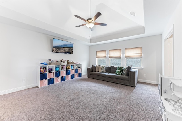 2880 Meadow Dell Dr, Prosper, TX 75078 - living room with a tray ceiling, a ceiling fan, carpet flooring, and baseboards
