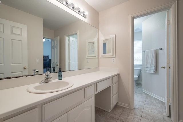 1312 Camberley Ct, Keller, TX 76248 - bathroom featuring vanity, toilet, tile patterned floors, baseboards, and ceiling fan