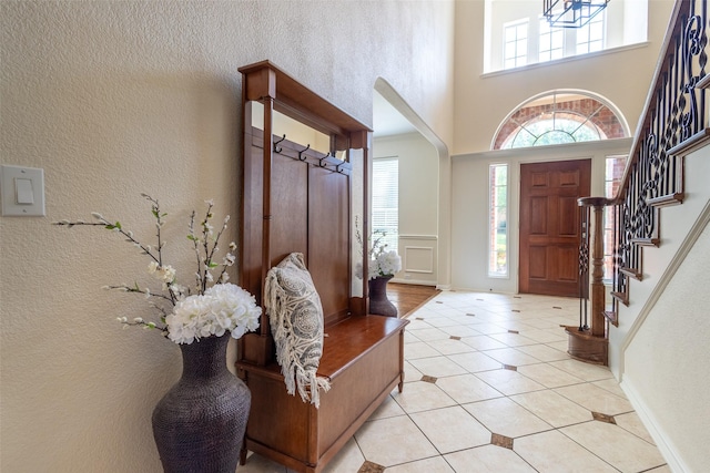 1312 Camberley Ct, Keller, TX 76248 - foyer featuring a high ceiling, light tile patterned floors, stairs, a textured wall, and baseboards