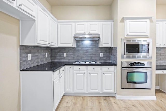 3104 Pataula Ln, Plano, TX 75074 - kitchen featuring stainless steel appliances, light wood-type flooring, white cabinets, and dark countertops