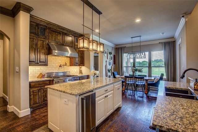 552 Horseshoe Bnd, Royse City, TX 75189 - kitchen with under cabinet range hood, a sink, beverage cooler, ornamental molding, and light stone countertops