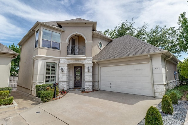 7904 Fair Oaks Ave, Dallas, TX 75231 - view of front of house with a balcony, stone siding, stucco siding, concrete driveway, and an attached garage