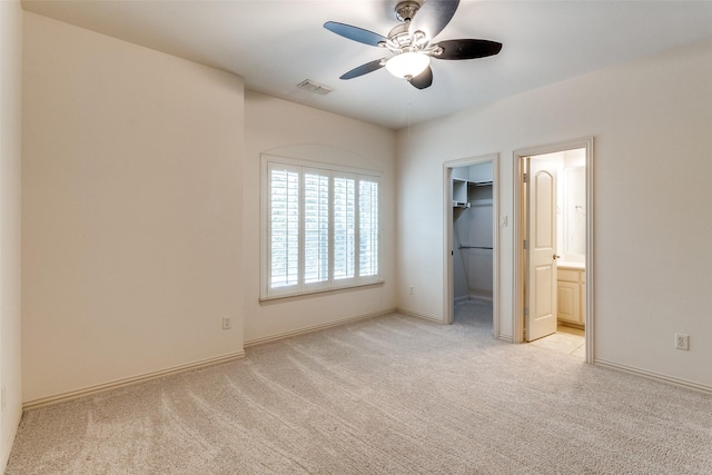 7904 Fair Oaks Ave, Dallas, TX 75231 - unfurnished bedroom with light carpet, a spacious closet, baseboards, and a ceiling fan