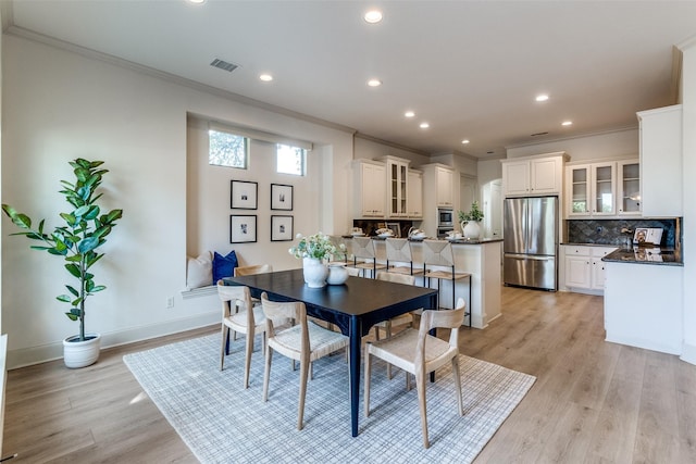 7904 Fair Oaks Ave, Dallas, TX 75231 - dining space with crown molding, recessed lighting, light wood-style flooring, and baseboards