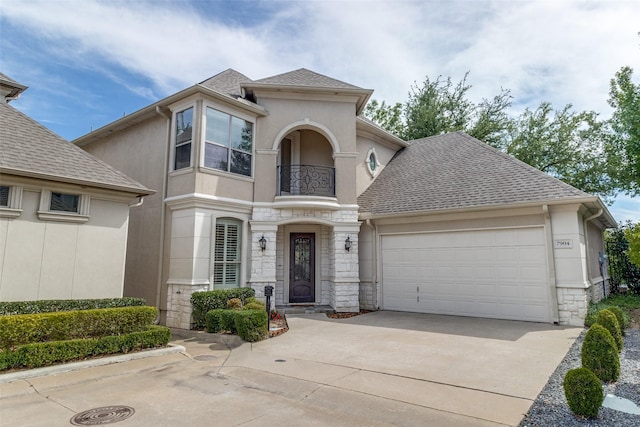 7904 Fair Oaks Ave, Dallas, TX 75231 - view of front of property with a balcony, stone siding, stucco siding, a garage, and driveway