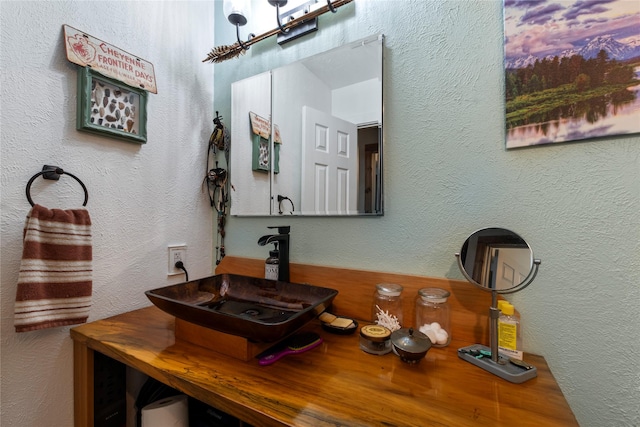 250 Whispering Oaks, Payne Springs, TX 75156 - bathroom featuring a textured wall and double vanity