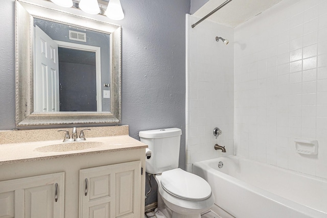 7107 Greenspring Dr, Arlington, TX 76016 - bathroom featuring toilet, a textured wall, vanity, and tub / shower combination