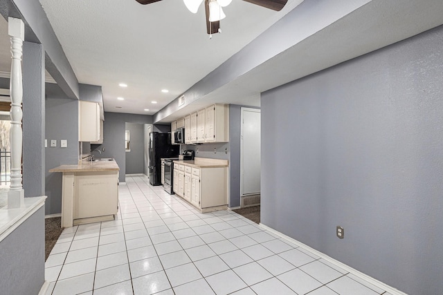 7107 Greenspring Dr, Arlington, TX 76016 - kitchen featuring stainless steel appliances, ceiling fan, light countertops, baseboards, and light tile patterned floors