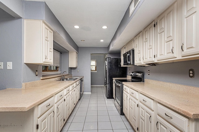 7107 Greenspring Dr, Arlington, TX 76016 - kitchen featuring appliances with stainless steel finishes, a sink, light countertops, light tile patterned floors, and recessed lighting