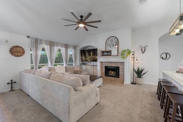 306 Hardeman Blvd, Justin, TX 76247 - living area with ceiling fan, a fireplace, lofted ceiling, baseboards, and arched walkways