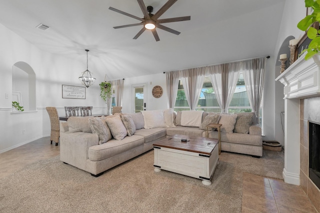306 Hardeman Blvd, Justin, TX 76247 - living area with ceiling fan, lofted ceiling, a chandelier, a fireplace, and arched walkways