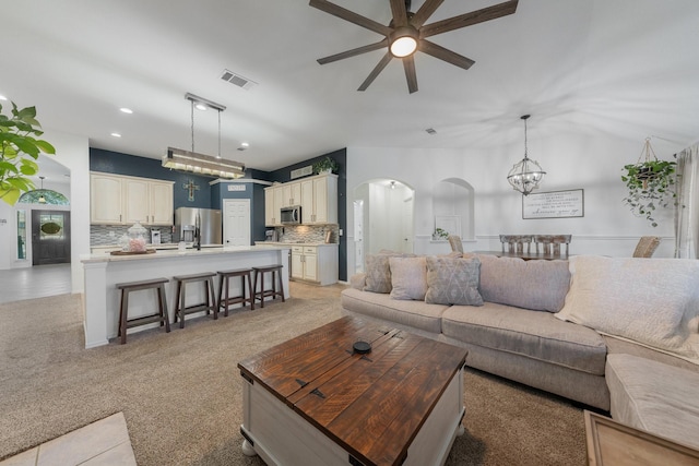 306 Hardeman Blvd, Justin, TX 76247 - living area with arched walkways, a ceiling fan, recessed lighting, light colored carpet, and lofted ceiling