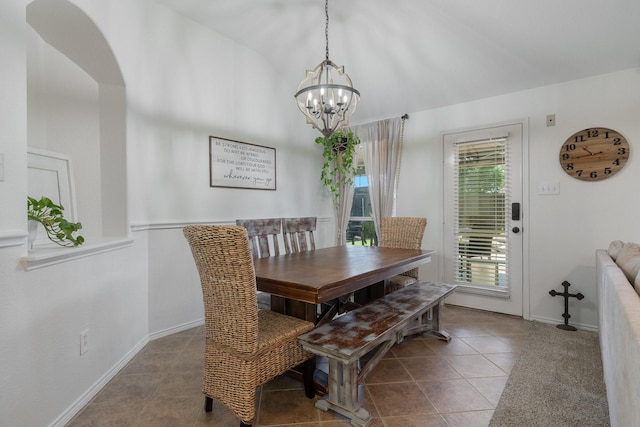 306 Hardeman Blvd, Justin, TX 76247 - dining space featuring a chandelier, baseboards, vaulted ceiling, tile patterned flooring, and arched walkways
