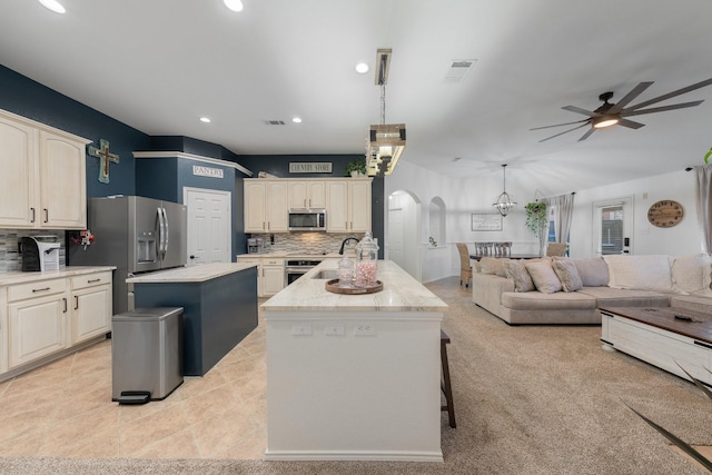 306 Hardeman Blvd, Justin, TX 76247 - kitchen featuring stainless steel appliances, an island with sink, arched walkways, backsplash, and recessed lighting
