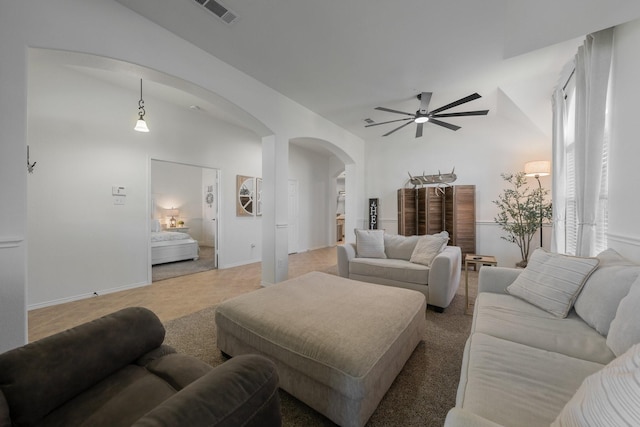 306 Hardeman Blvd, Justin, TX 76247 - living room with arched walkways, ceiling fan, and baseboards